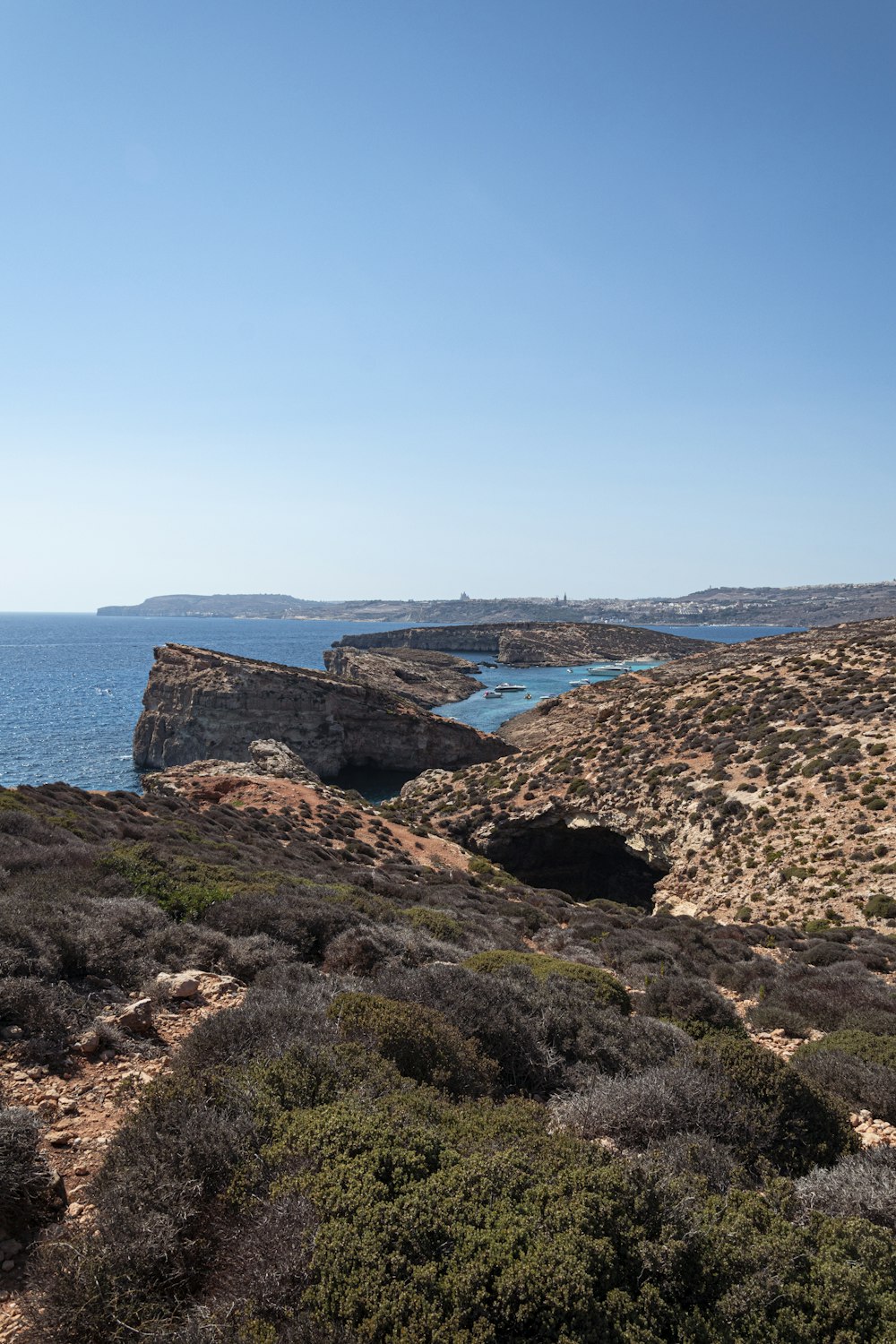 a large body of water sitting on top of a lush green hillside