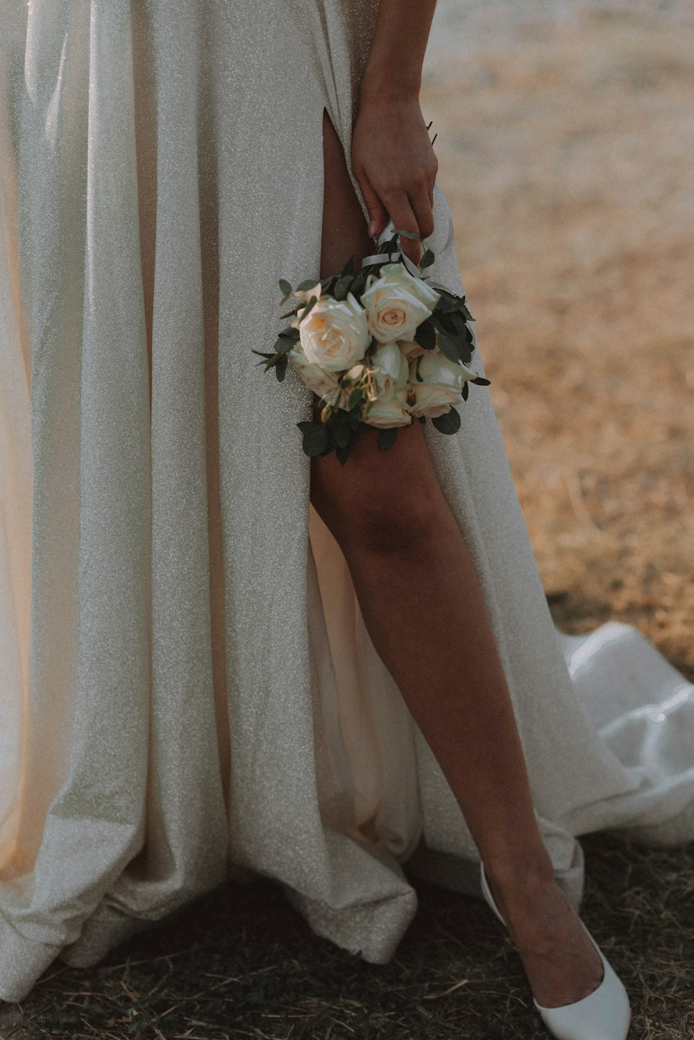 a close up of a person holding a bouquet of flowers