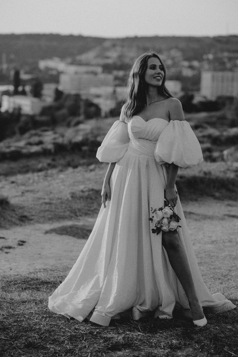 a woman in a white dress standing in a field