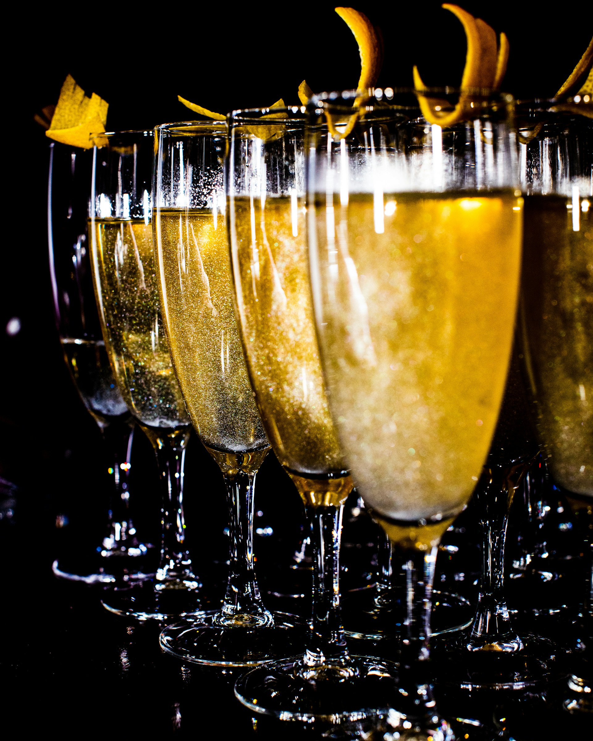 a row of champagne glasses filled with champagne