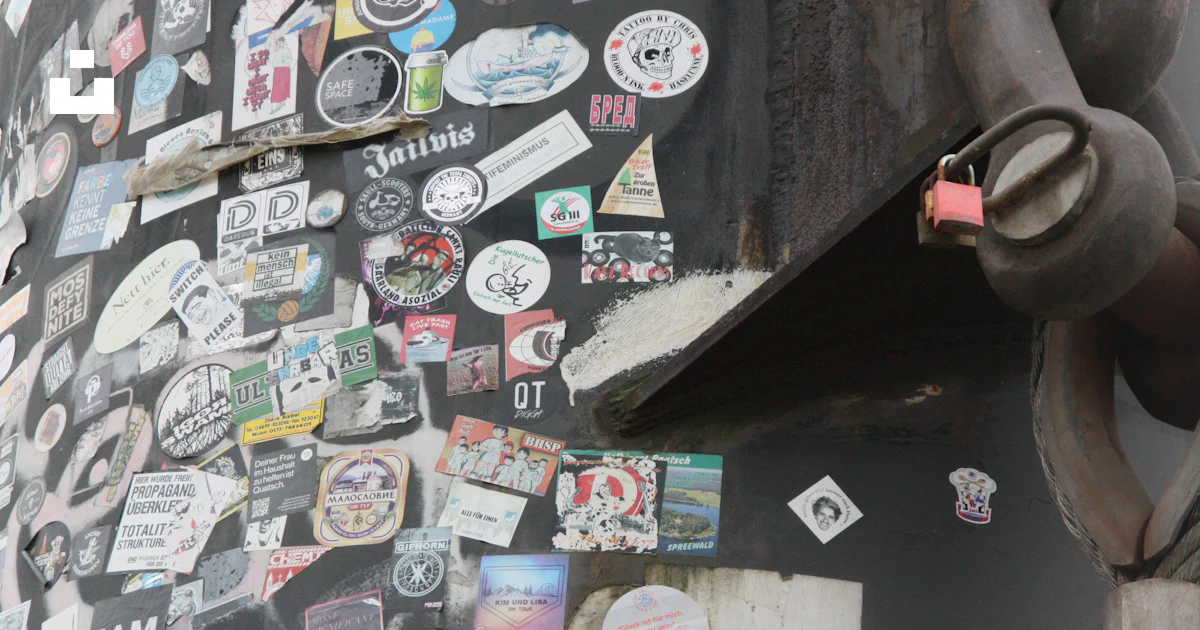 A close up of a building with a bunch of stickers on it photo – Free ...