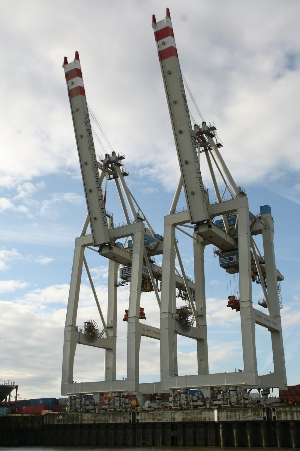 two large cranes sitting on top of a pier