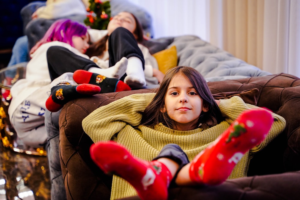 a group of people laying on top of a couch