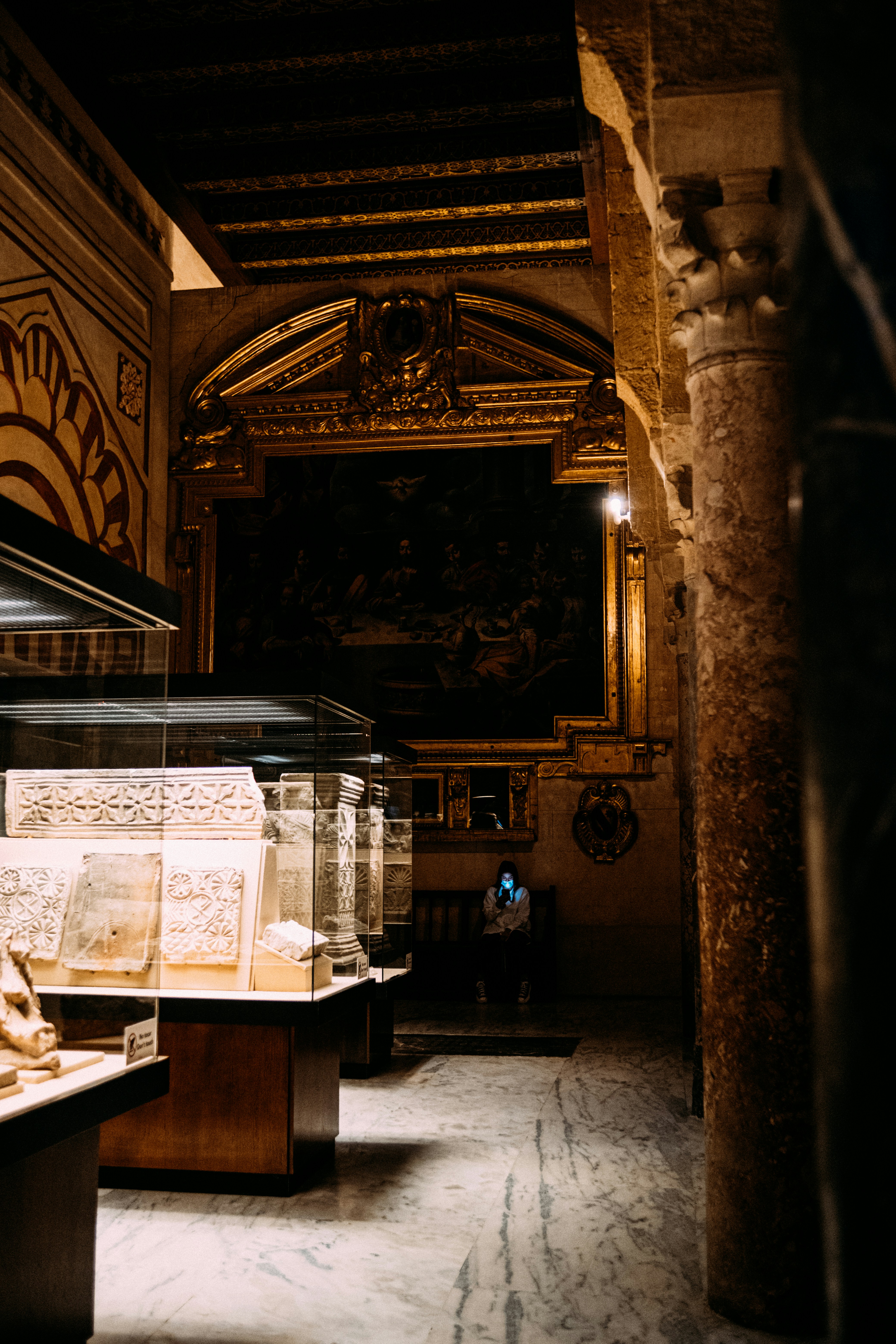 a room filled with lots of glass cases filled with books