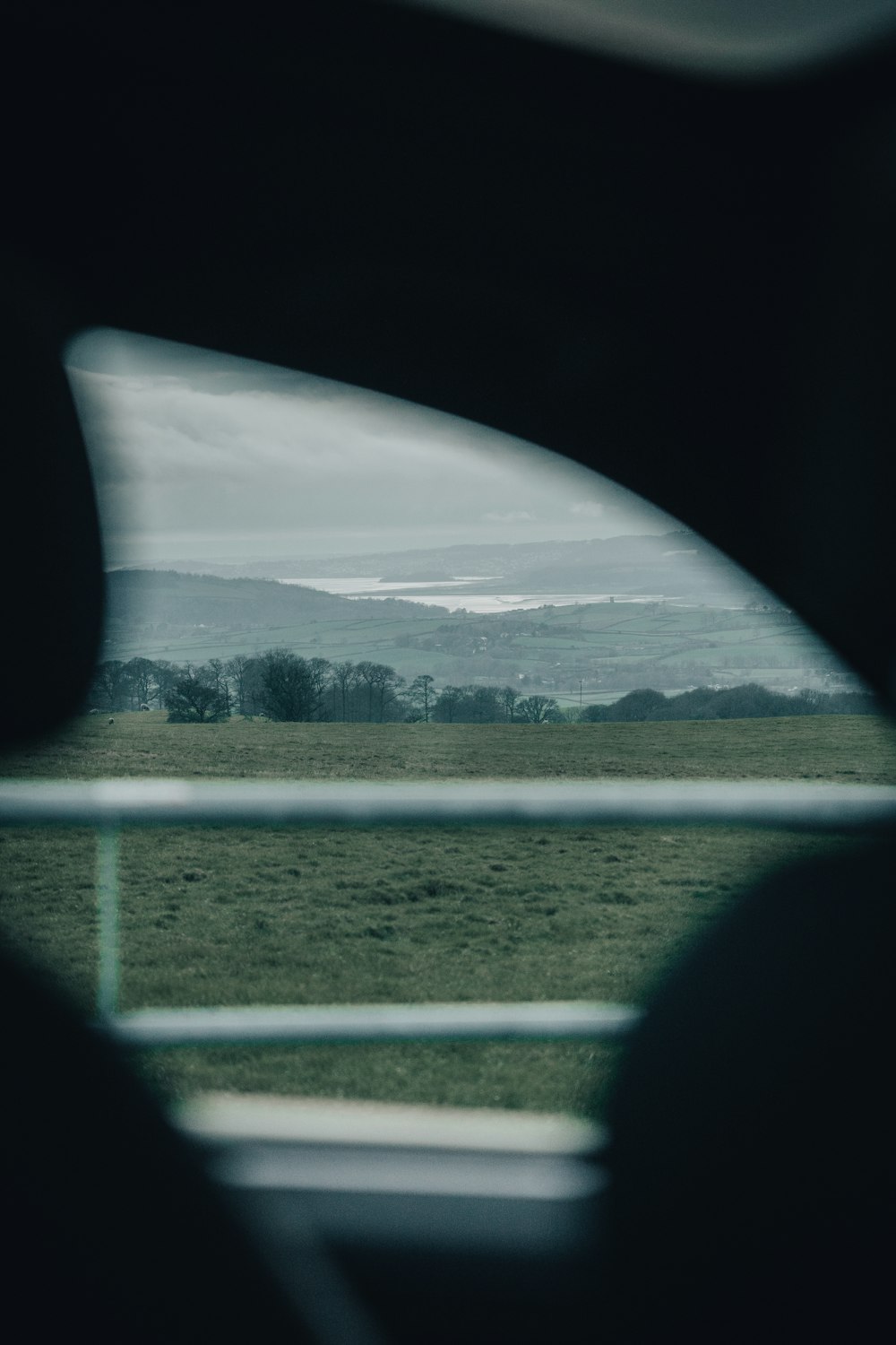 a view of a field from inside a vehicle