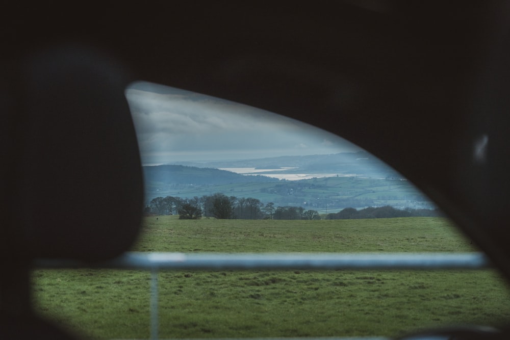 a view of a field from inside a vehicle