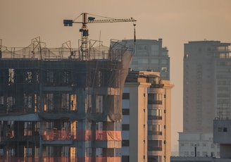 a tall building with a crane on top of it