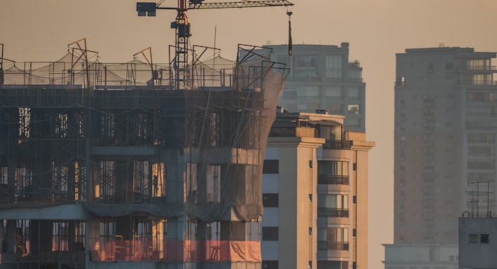 a tall building with a crane on top of it