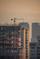 a tall building with a crane on top of it