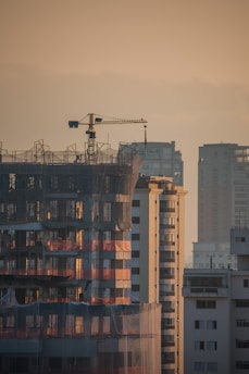a tall building with a crane on top of it