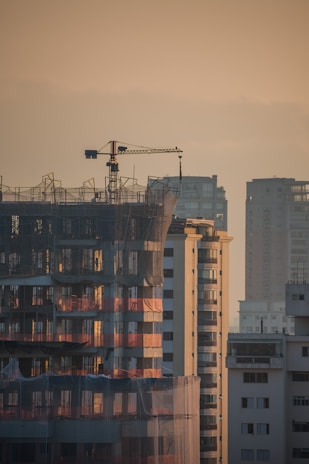 a tall building with a crane on top of it