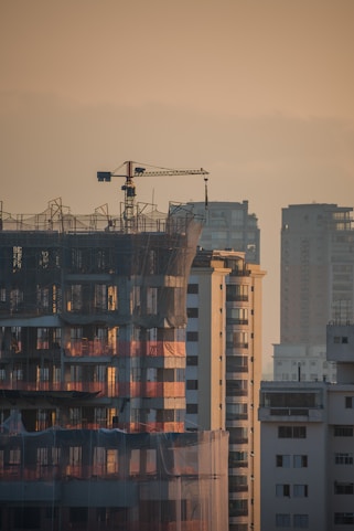 a tall building with a crane on top of it