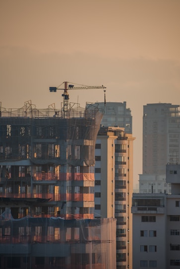 a tall building with a crane on top of it