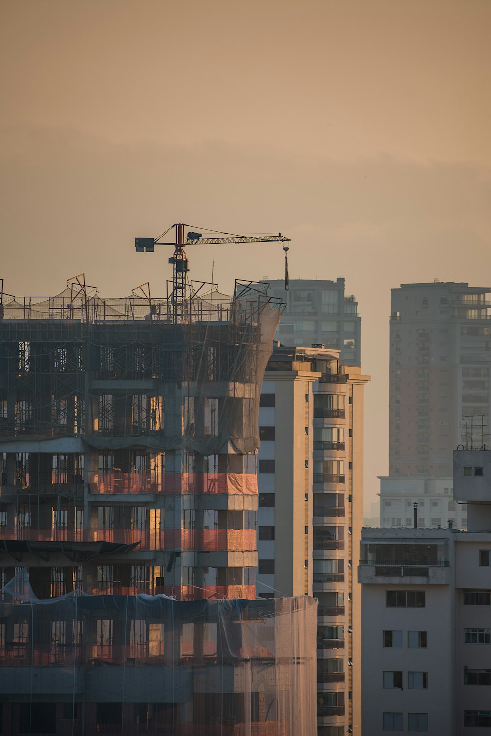 a tall building with a crane on top of it