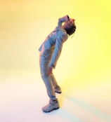 a man in a gray suit and sneakers