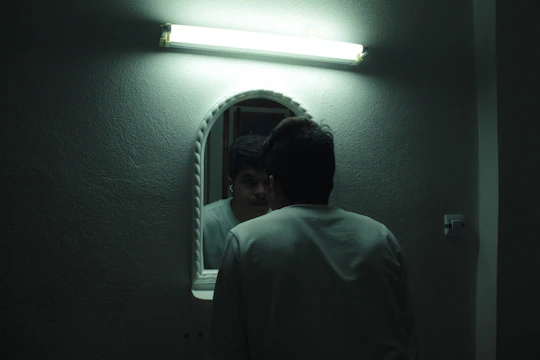 The same bathroom mirror now glowing evenly with smooth, frameless LED lighting and no visible dots.