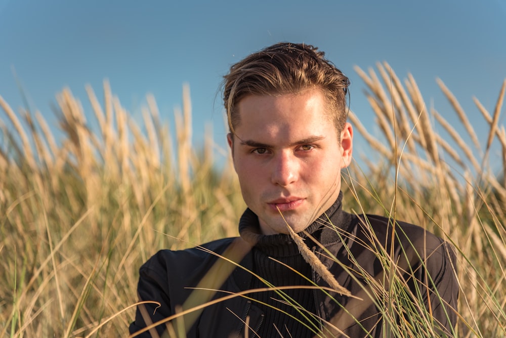 a man standing in a field of tall grass