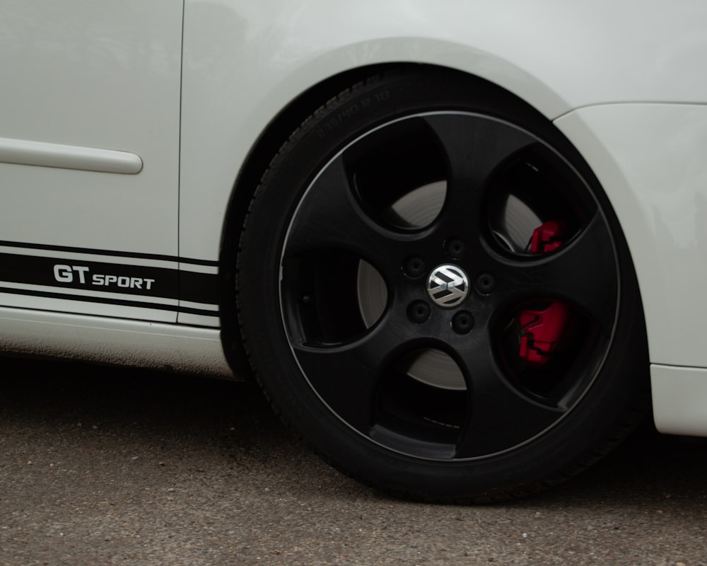 a close up of a white sports car tire