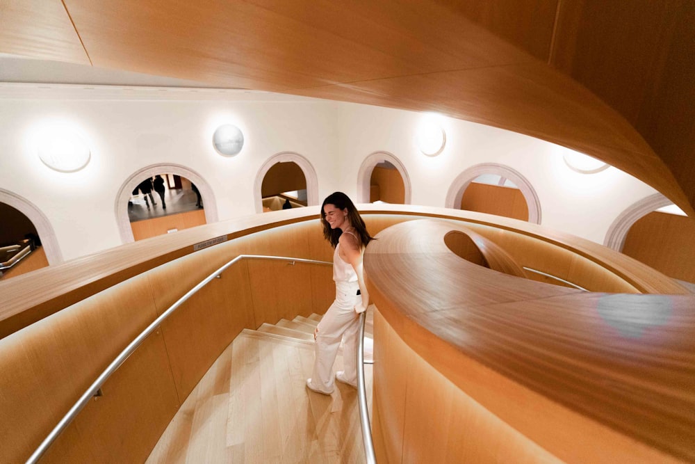 a woman standing on a staircase in a building