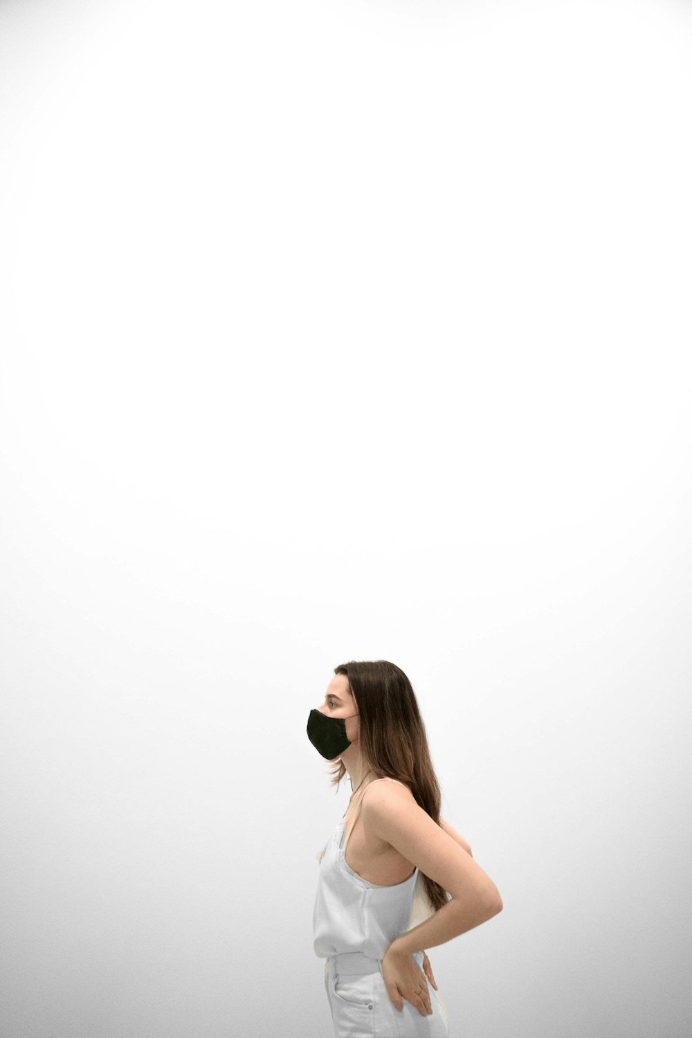 a woman standing in front of a white wall