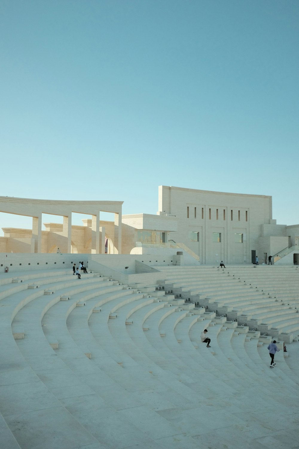 a group of people standing on top of a white stage