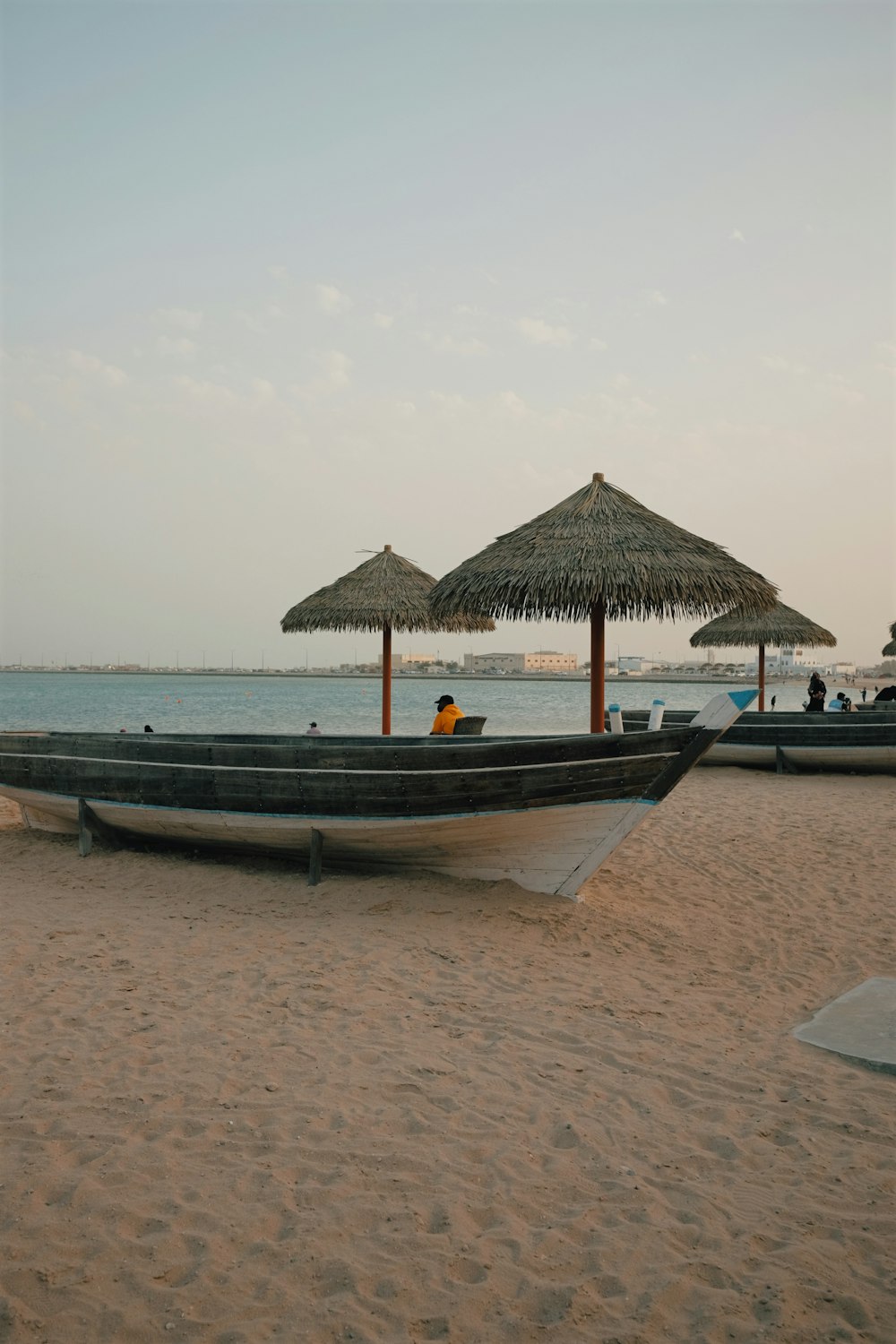 a boat sitting on top of a sandy beach