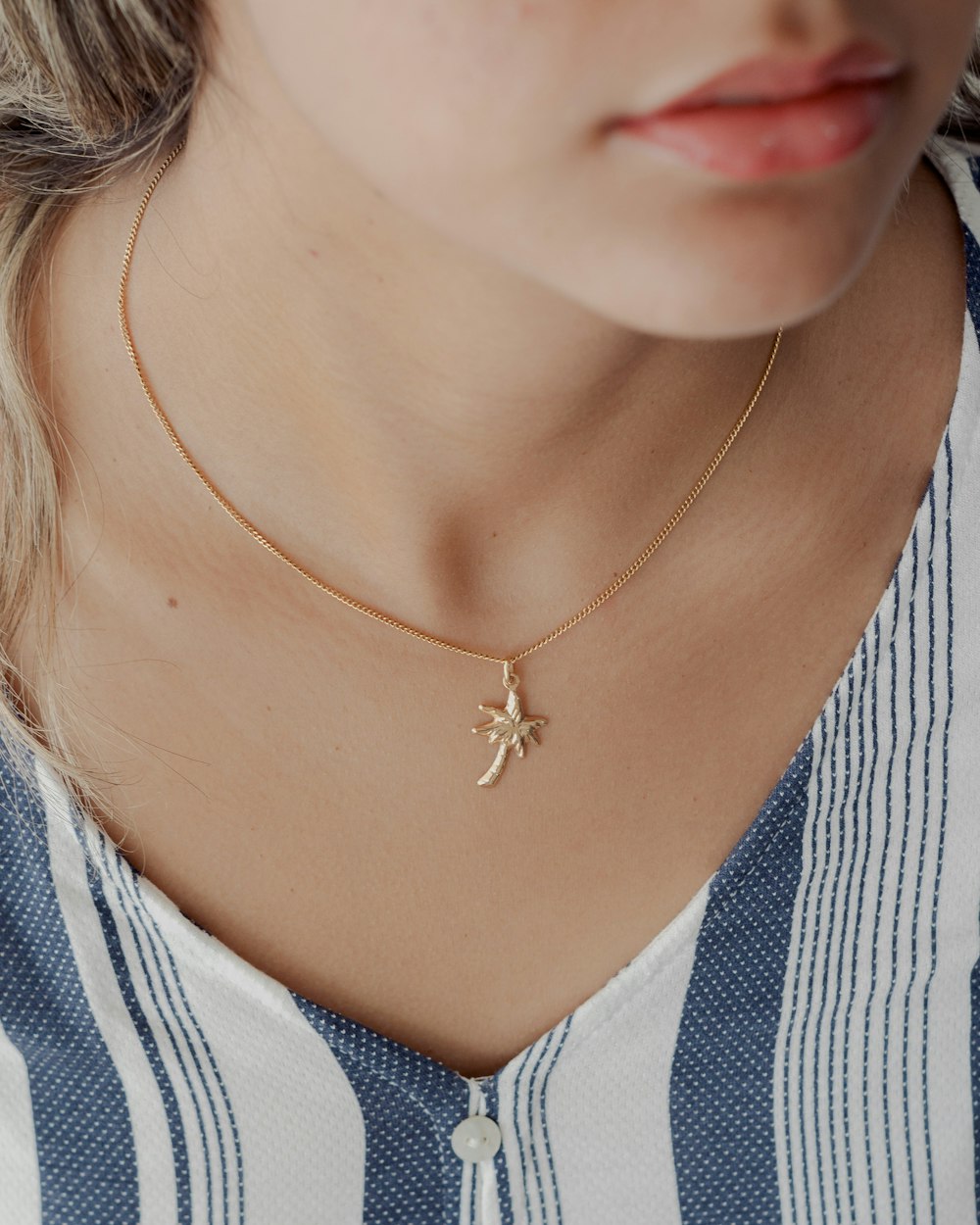 a close up of a woman wearing a necklace