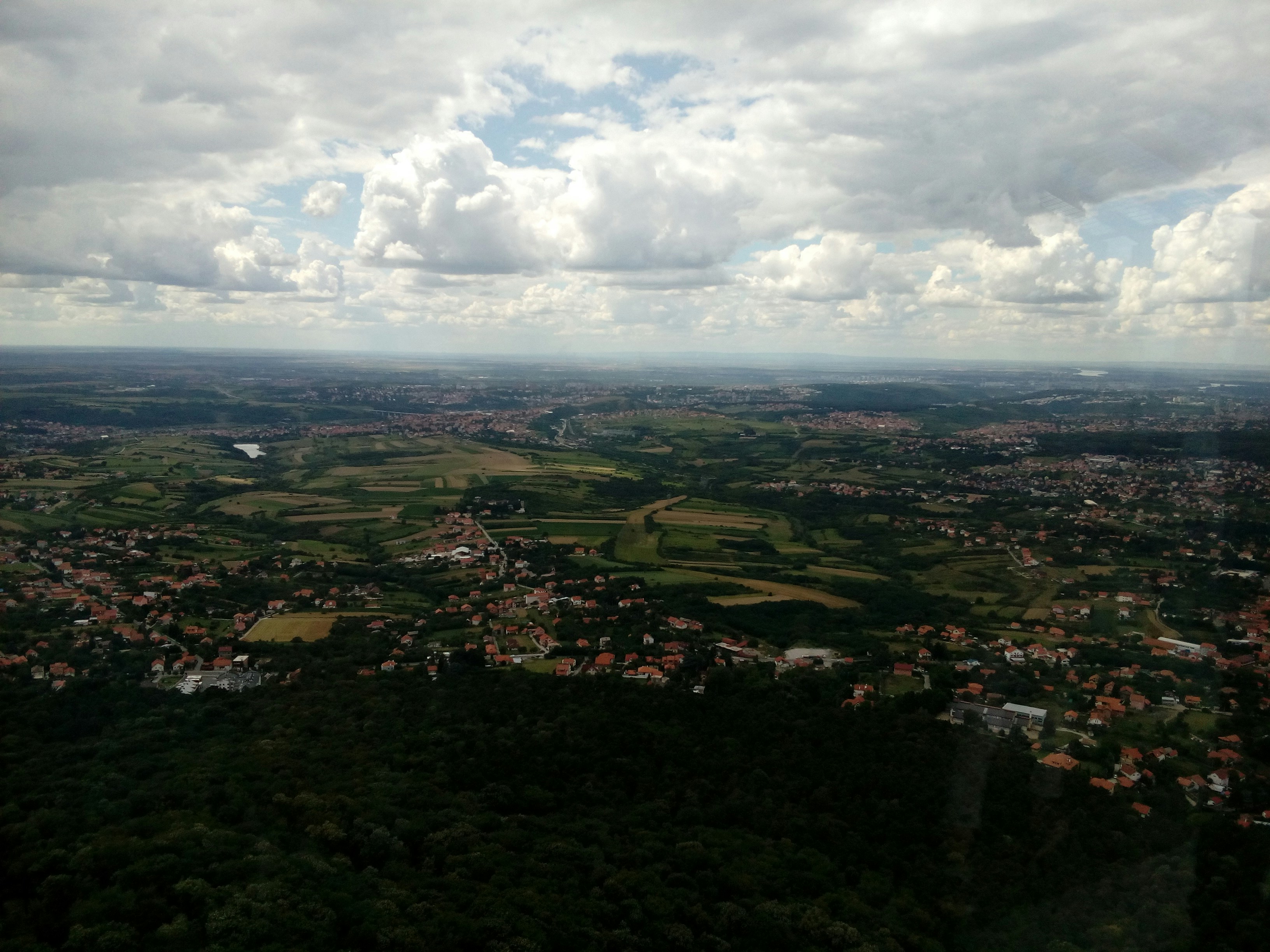 an aerial view of a small town surrounded by trees