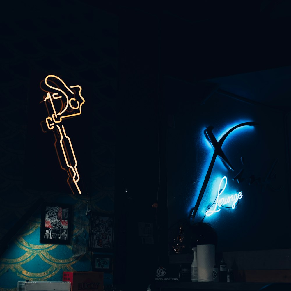 a dark room with two neon signs on the wall