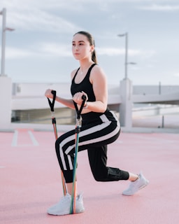 a woman in a black and white outfit is holding a cane