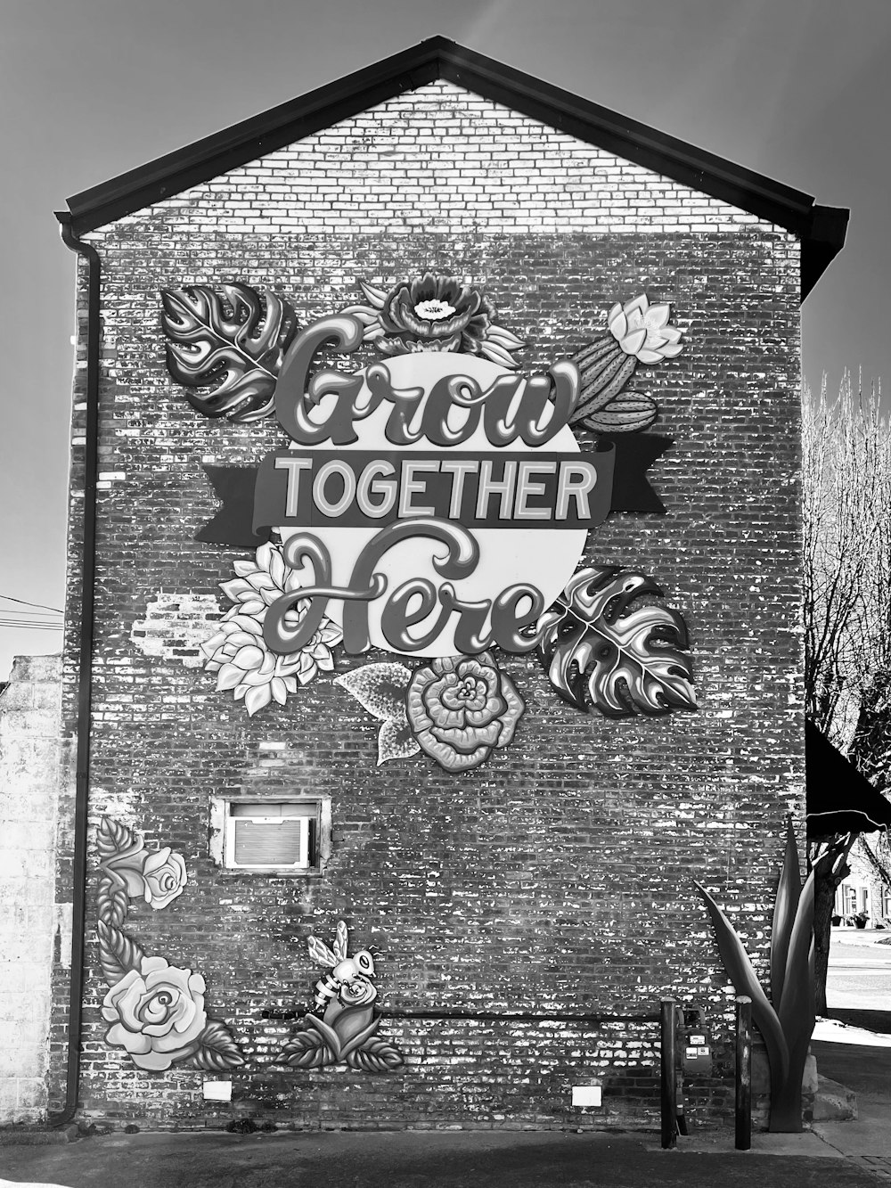 a black and white photo of a sign on a building