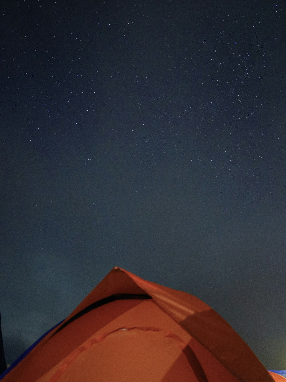 a tent with a sky full of stars in the background