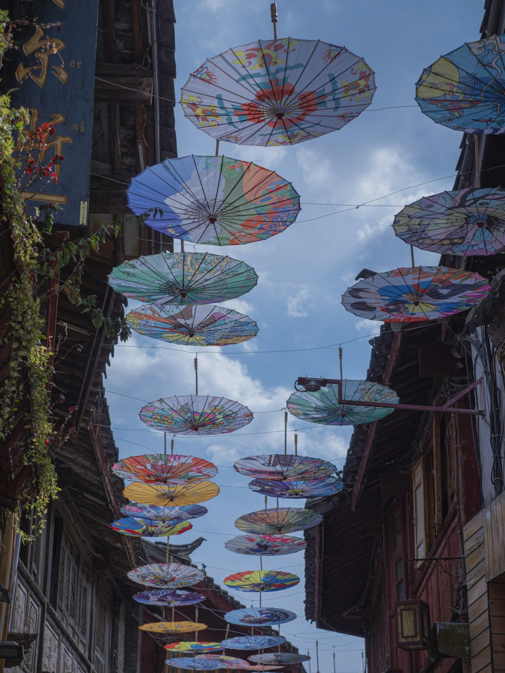 a group of umbrellas hanging from the side of a building