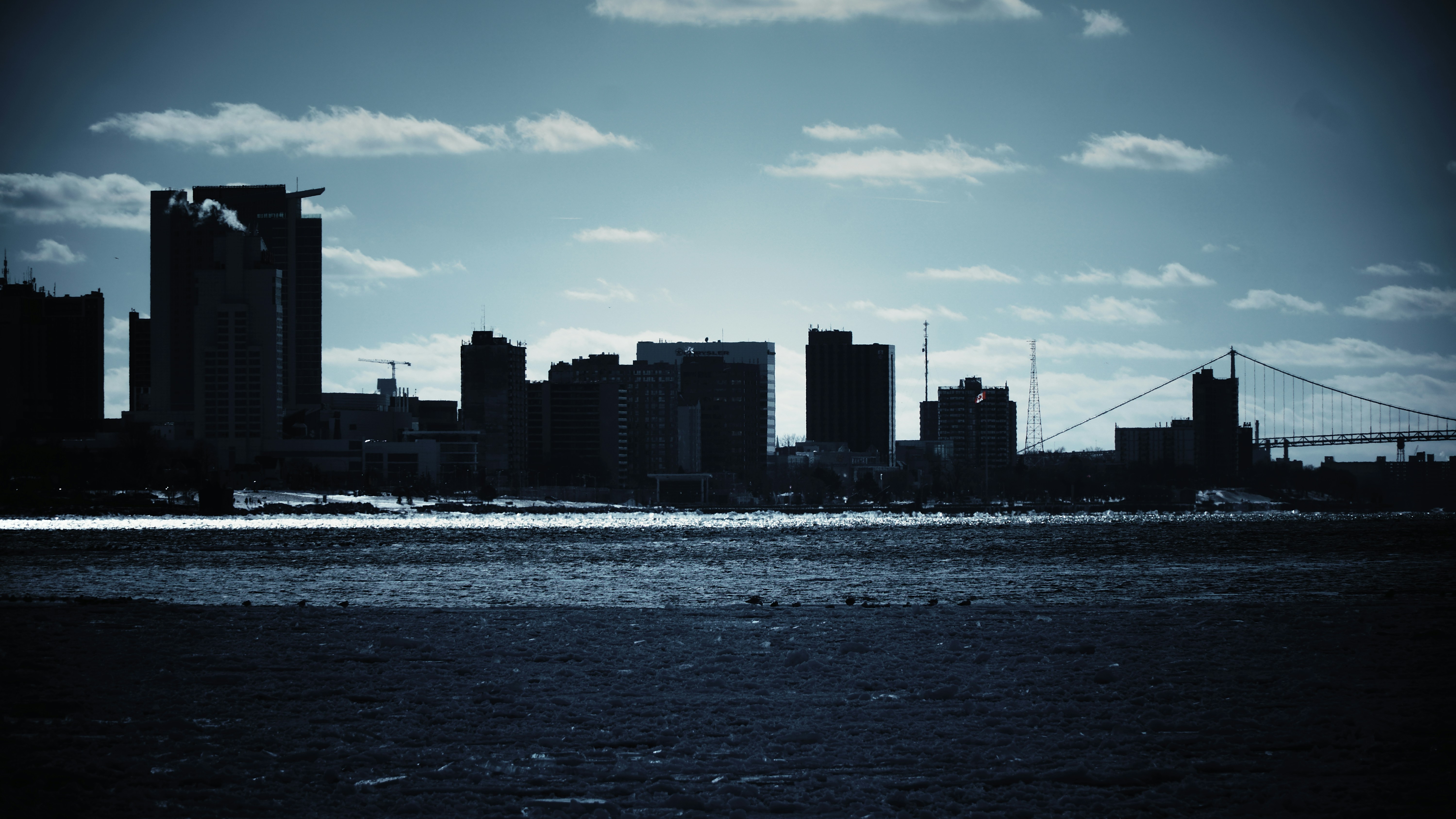 a city skyline with a bridge in the background