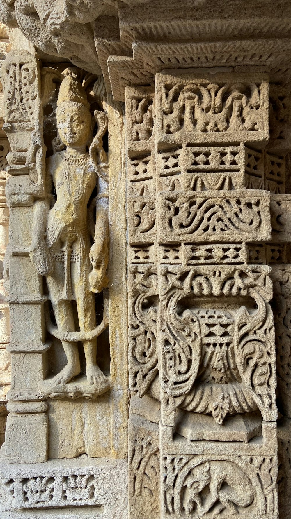 a stone carving of a man holding a horse