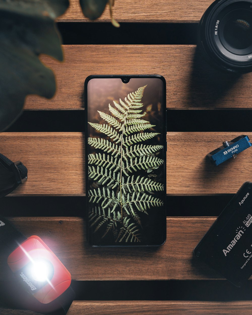 a cell phone sitting on top of a wooden table