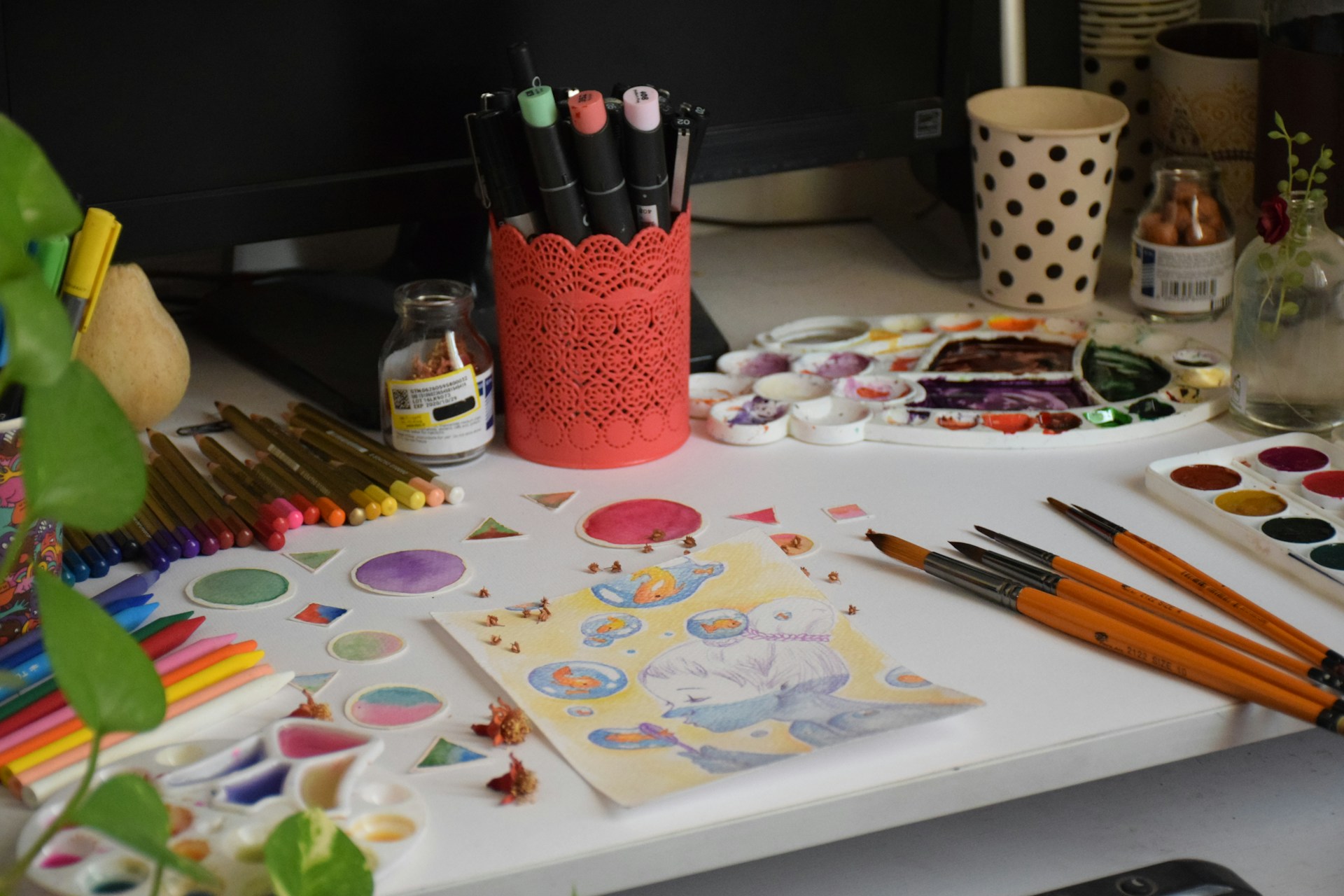 a table topped with lots of art supplies