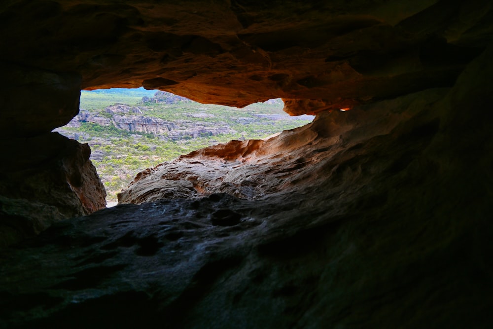 a cave with a view of a valley below