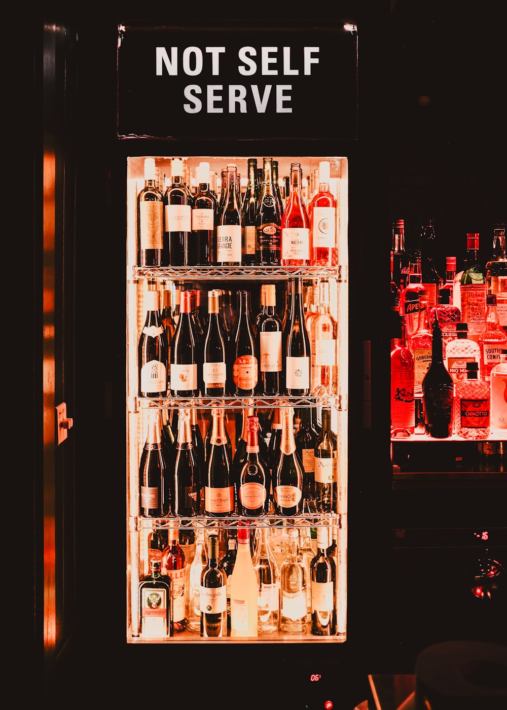 a display case filled with lots of bottles of wine