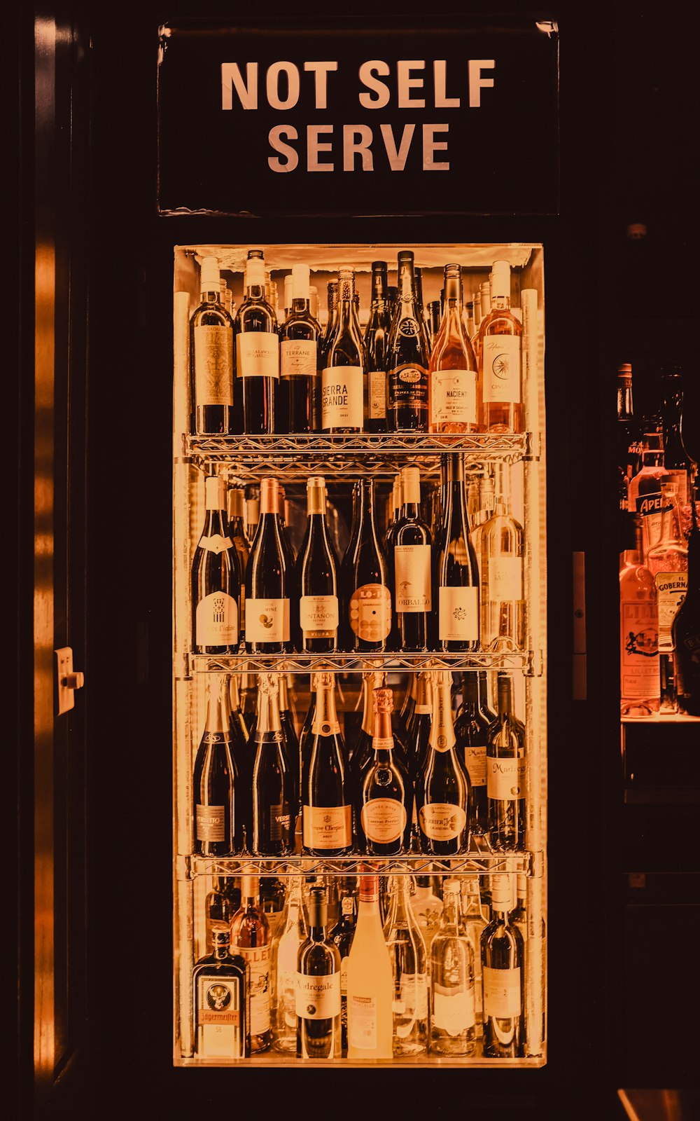 a refrigerator filled with lots of bottles of wine