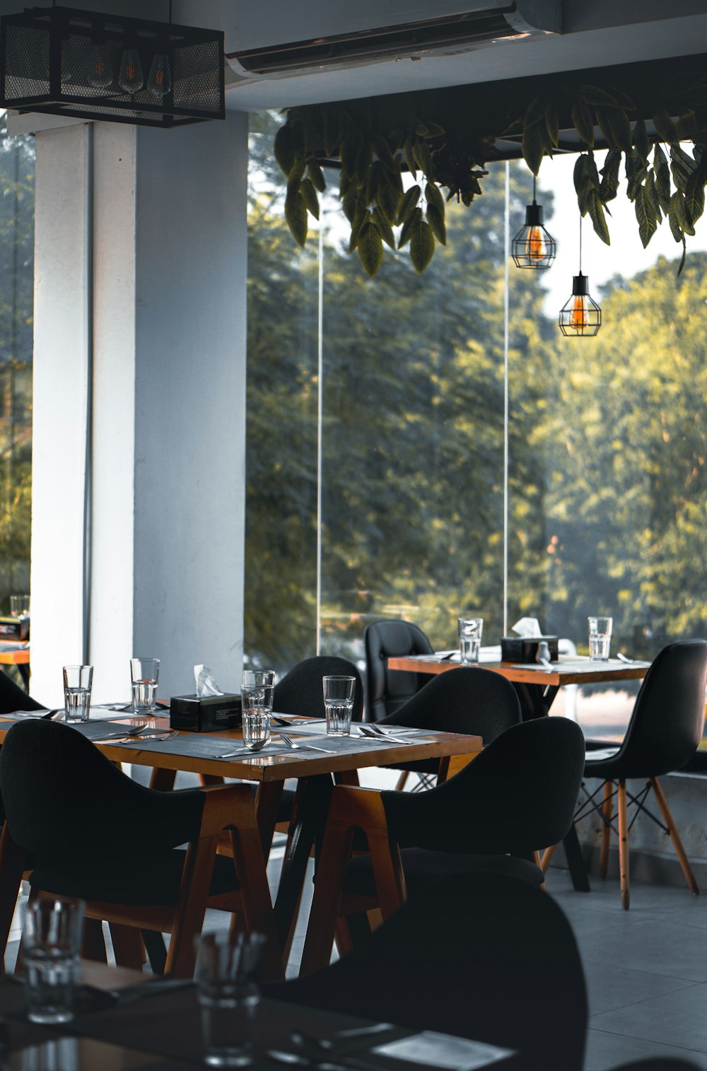 a restaurant with tables and chairs and a large window