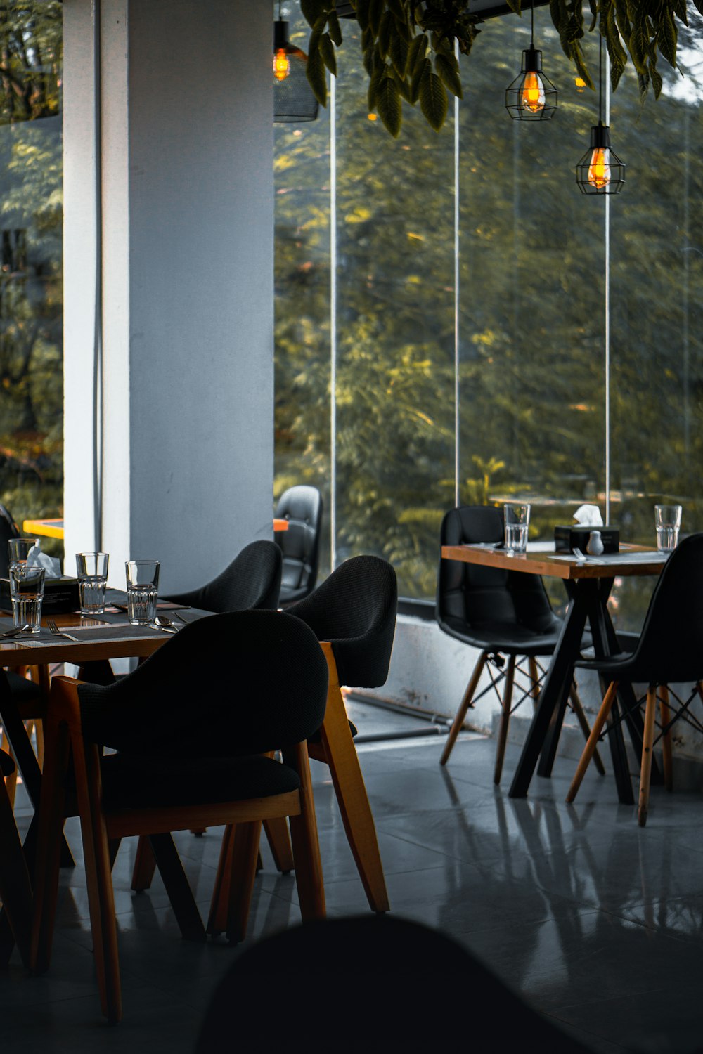 a restaurant with tables and chairs and a large window