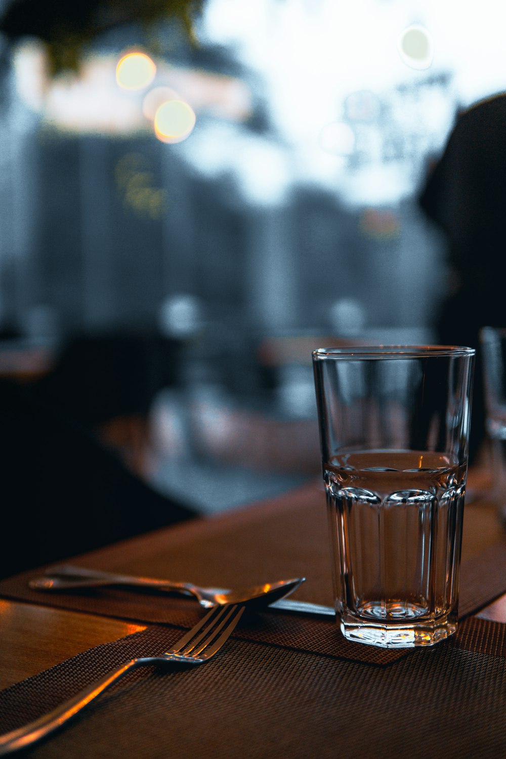 a glass of water sitting on top of a wooden table