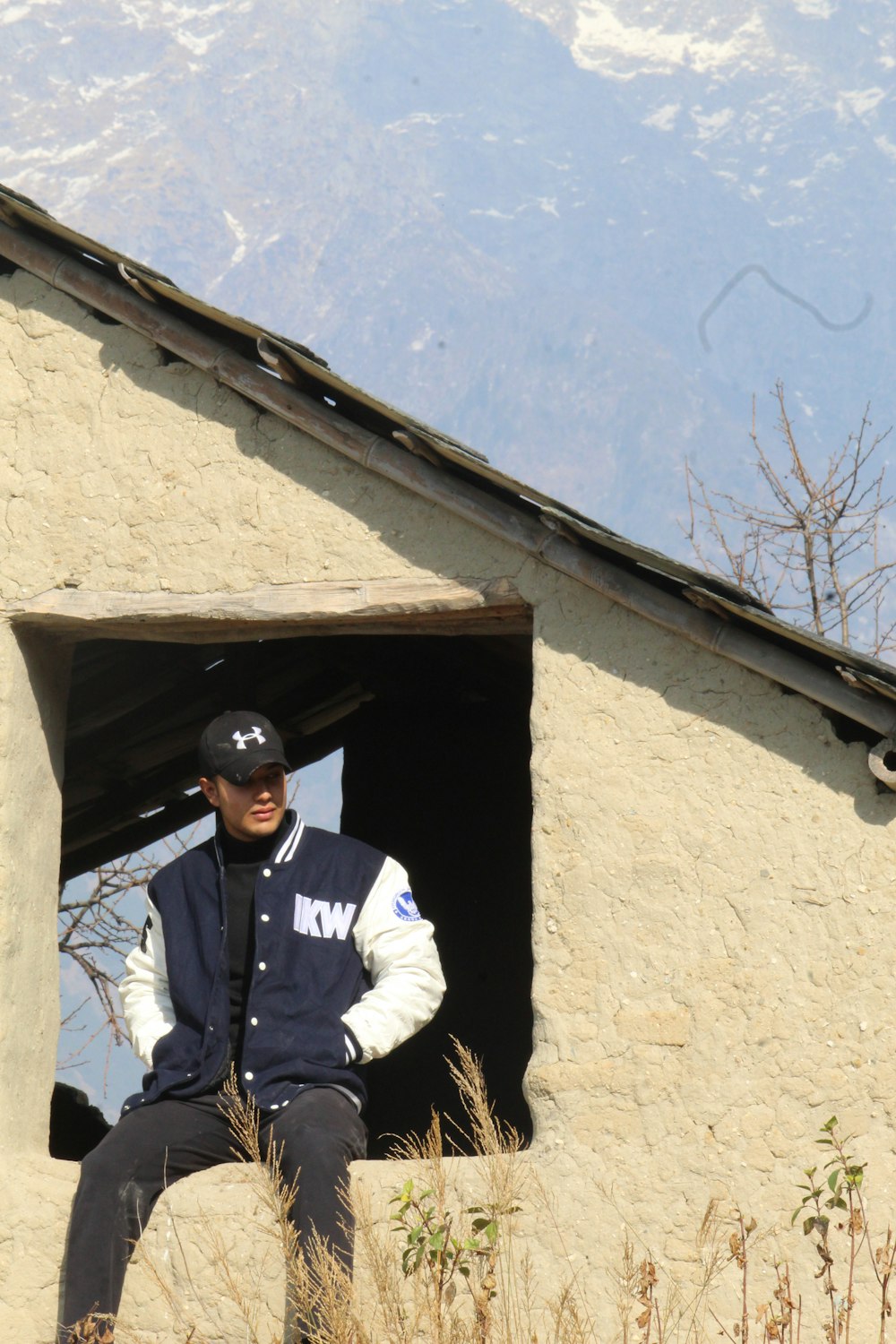 a man sitting in a window of a building