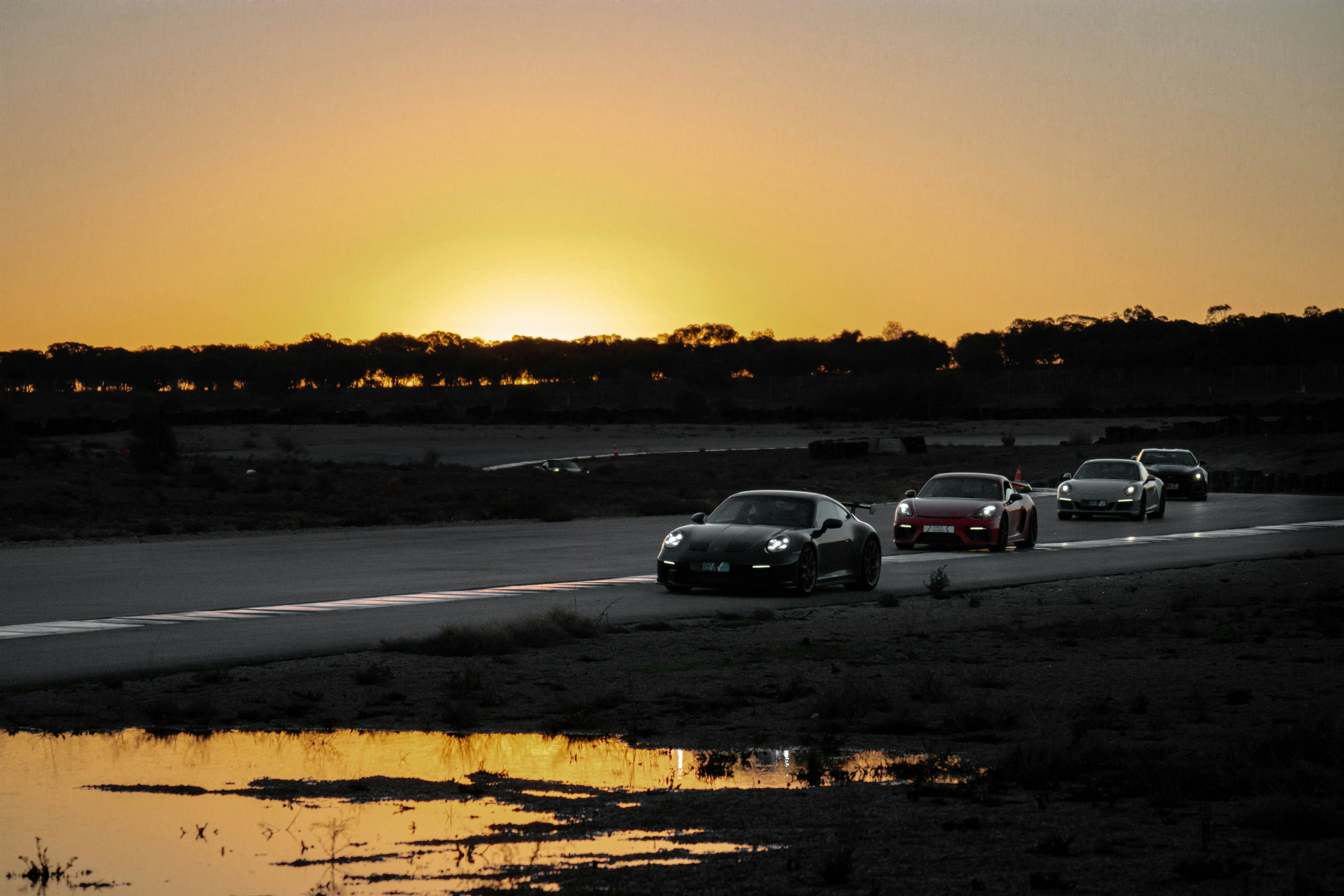 Sports car racing through Mexican landscape with dramatic sunset and warm colors