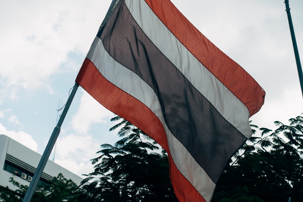 a large american flag flying in the wind