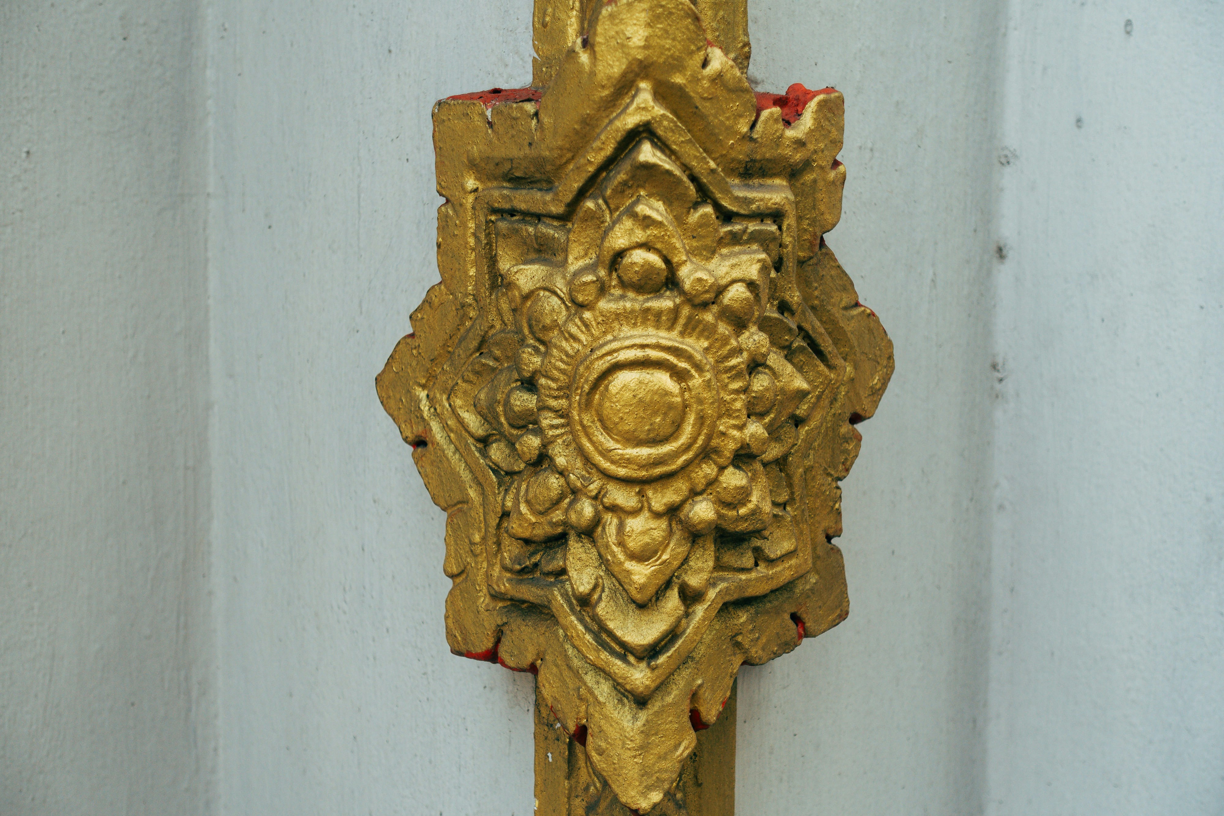 a gold door handle on a white door