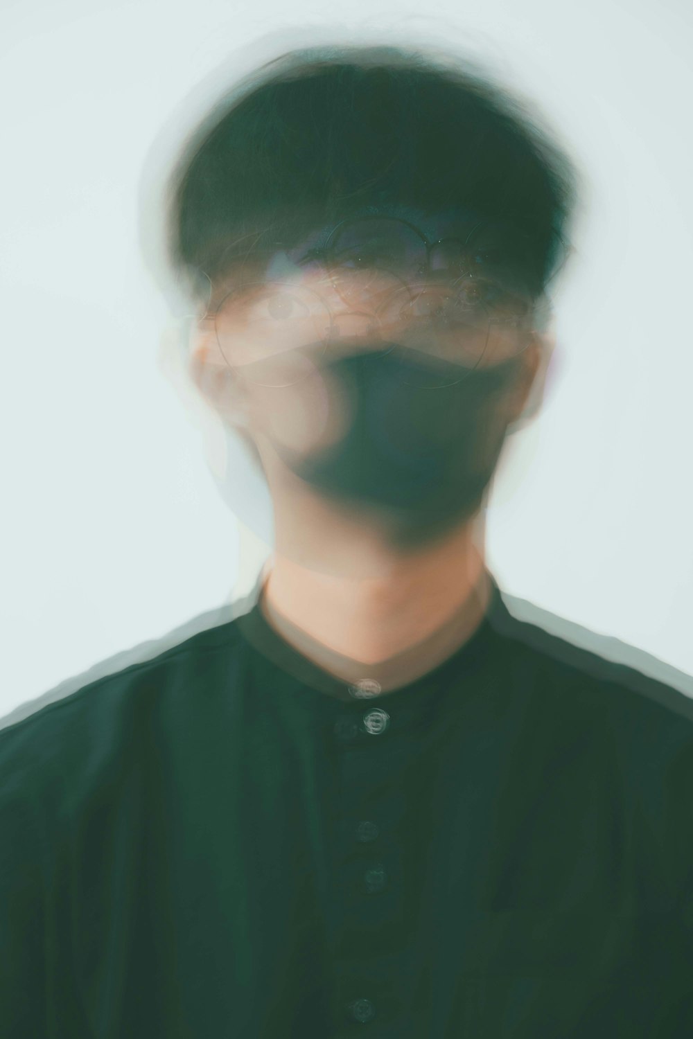 a blurry image of a man in a black shirt