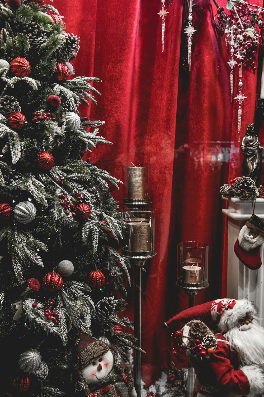 a christmas tree in front of a red curtain