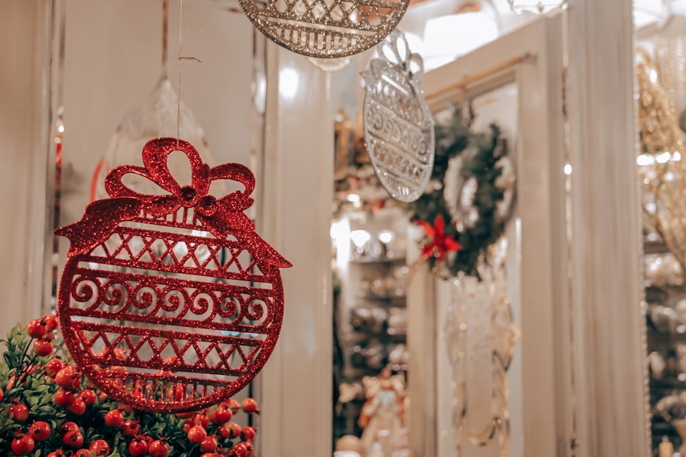 a red christmas ornament hanging from a chandelier